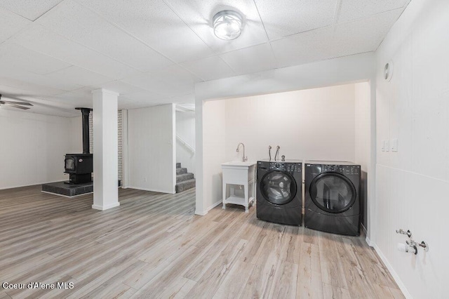 16 Beers Humbird Rd, Sagle, ID 83860 - washroom with washer and clothes dryer, a wood stove, and wood finished floors