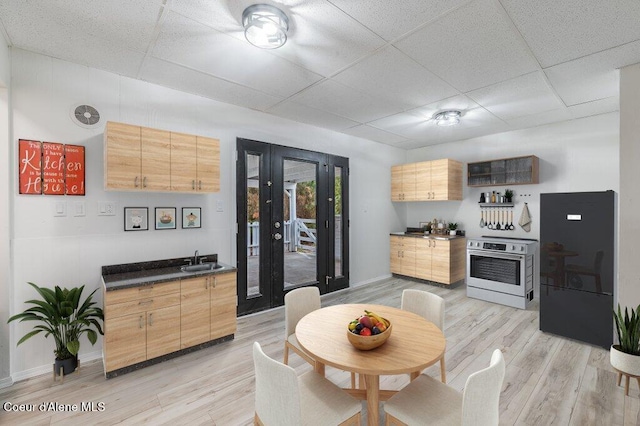 16 Beers Humbird Rd, Sagle, ID 83860 - kitchen with a paneled ceiling, dark countertops, freestanding refrigerator, oven, and light wood-style floors