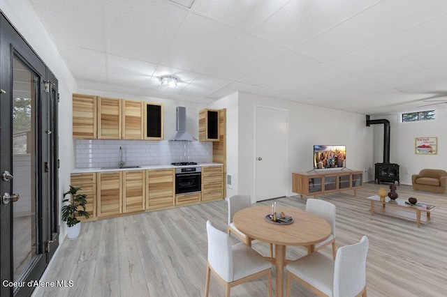 16 Beers Humbird Rd, Sagle, ID 83860 - dining area with a wood stove, plenty of natural light, light wood-type flooring, and a drop ceiling