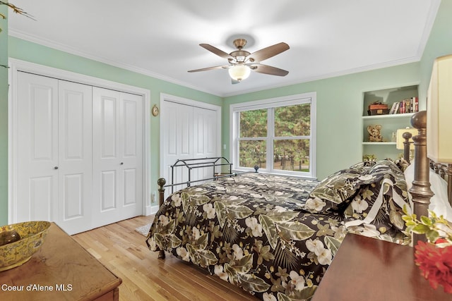 2177 E Totten Ln, Dalton Gardens, ID 83815 - bedroom with two closets, wood finished floors, ornamental molding, and a ceiling fan