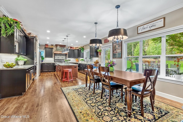 2177 E Totten Ln, Dalton Gardens, ID 83815 - dining room with a chandelier, wood finished floors, crown molding, baseboards, and recessed lighting