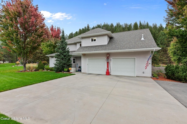 2177 E Totten Ln, Dalton Gardens, ID 83815 - view of front facade with concrete driveway, a front yard, roof with shingles, and an attached garage