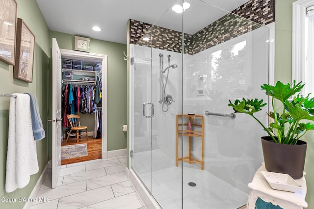 2177 E Totten Ln, Dalton Gardens, ID 83815 - bathroom with a shower stall, recessed lighting, marble look tiles, a spacious closet, and baseboards