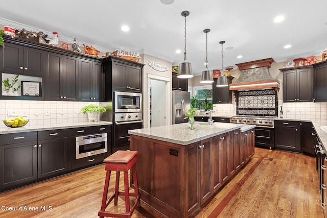 2177 E Totten Ln, Dalton Gardens, ID 83815 - kitchen with stainless steel appliances, premium range hood, decorative backsplash, ornamental molding, and recessed lighting