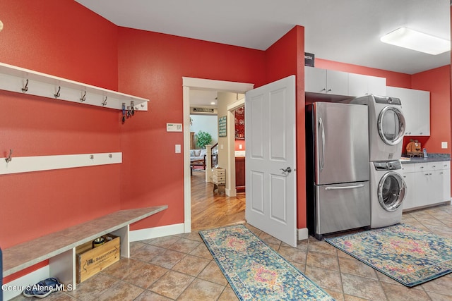 2177 E Totten Ln, Dalton Gardens, ID 83815 - washroom with stacked washer / dryer, baseboards, and light stone finish floors