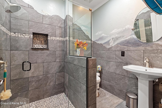 2177 E Totten Ln, Dalton Gardens, ID 83815 - bathroom featuring tile walls, toilet, a shower stall, ornamental molding, and a sink