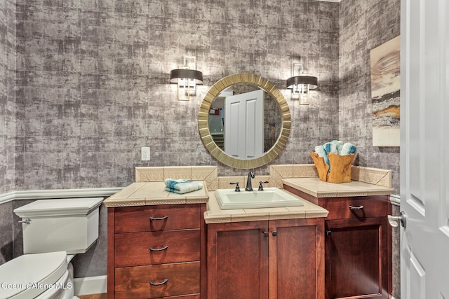 2177 E Totten Ln, Dalton Gardens, ID 83815 - bathroom with toilet, vanity, and wallpapered walls