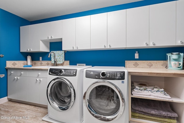 2177 E Totten Ln, Dalton Gardens, ID 83815 - washroom featuring cabinet space, separate washer and dryer, light wood finished floors, and baseboards