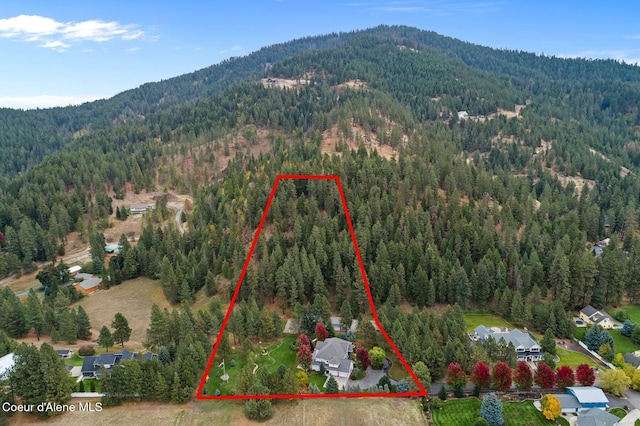 2177 E Totten Ln, Dalton Gardens, ID 83815 - aerial overview of property's location featuring a heavily wooded area, mountains, and property boundaries highlighted