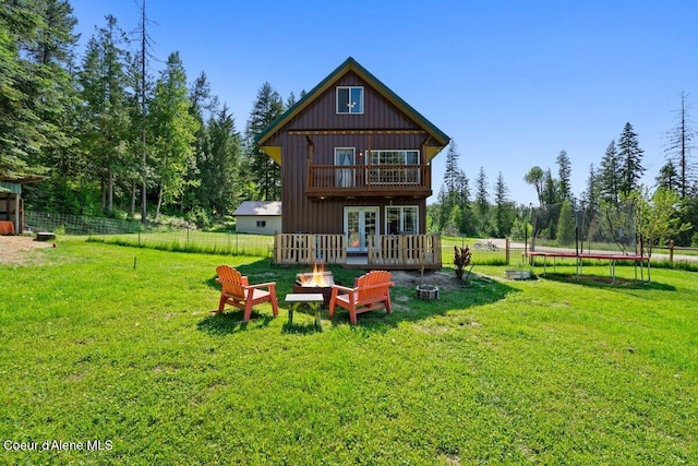 929 Irish Rd, Sagle, ID 83860 - rear view of house featuring a trampoline and a wooden deck