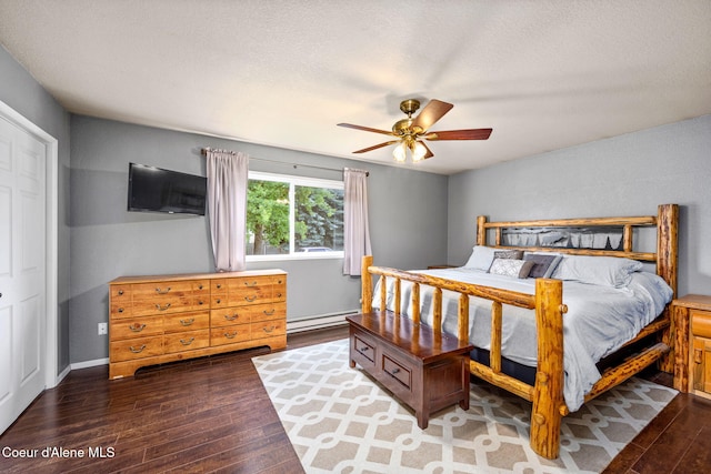 8525 W Nevada St, Rathdrum, ID 83858 - bedroom featuring baseboard heating, hardwood / wood-style flooring, ceiling fan, and a textured ceiling