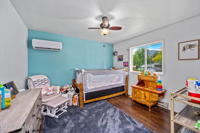 8525 W Nevada St, Rathdrum, ID 83858 - bedroom with a wall unit AC, wood-type flooring, a ceiling fan, and baseboards