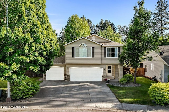 5735 E Steamboat Bnd, Post Falls, ID 83854 - view of front of house featuring concrete driveway, stone siding, and a garage
