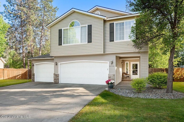 5735 E Steamboat Bnd, Post Falls, ID 83854 - view of front of house featuring an attached garage, driveway, and stone siding