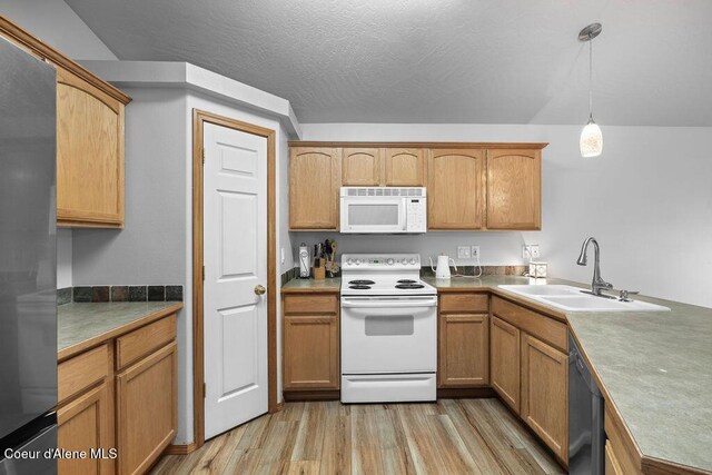 5735 E Steamboat Bnd, Post Falls, ID 83854 - kitchen featuring white appliances, a sink, light wood-style floors, decorative light fixtures, and a textured ceiling