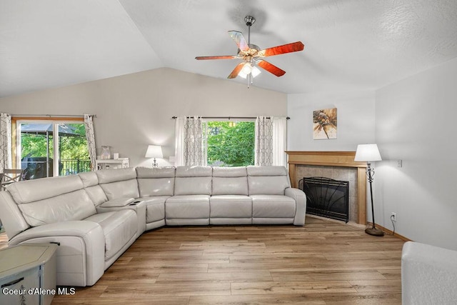 5735 E Steamboat Bnd, Post Falls, ID 83854 - living room featuring lofted ceiling, a ceiling fan, plenty of natural light, a tile fireplace, and light wood finished floors