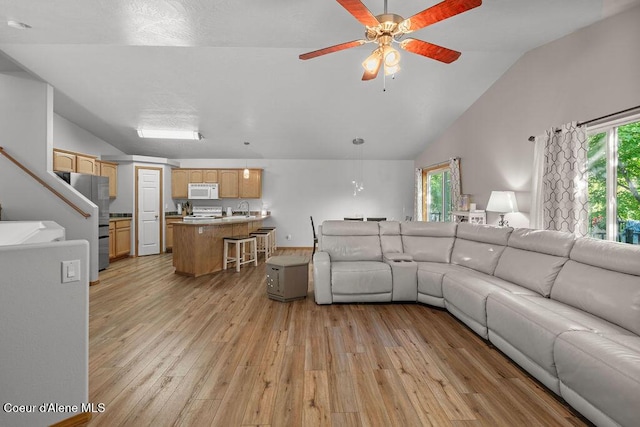 5735 E Steamboat Bnd, Post Falls, ID 83854 - living room with lofted ceiling, light wood-style floors, and a ceiling fan