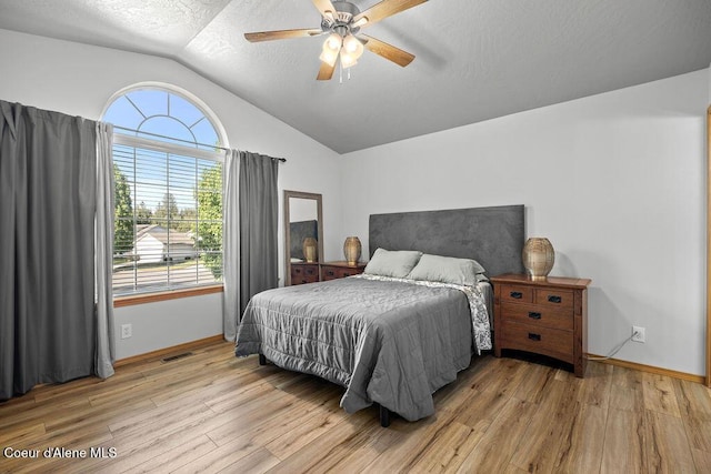 5735 E Steamboat Bnd, Post Falls, ID 83854 - bedroom with vaulted ceiling, light wood-type flooring, baseboards, a textured ceiling, and ceiling fan