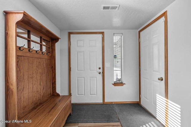 5735 E Steamboat Bnd, Post Falls, ID 83854 - mudroom featuring a textured ceiling and baseboards