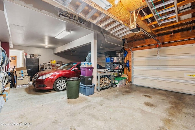 5735 E Steamboat Bnd, Post Falls, ID 83854 - garage with a garage door opener and freestanding refrigerator
