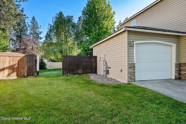 5735 E Steamboat Bnd, Post Falls, ID 83854 - view of yard with a garage and concrete driveway
