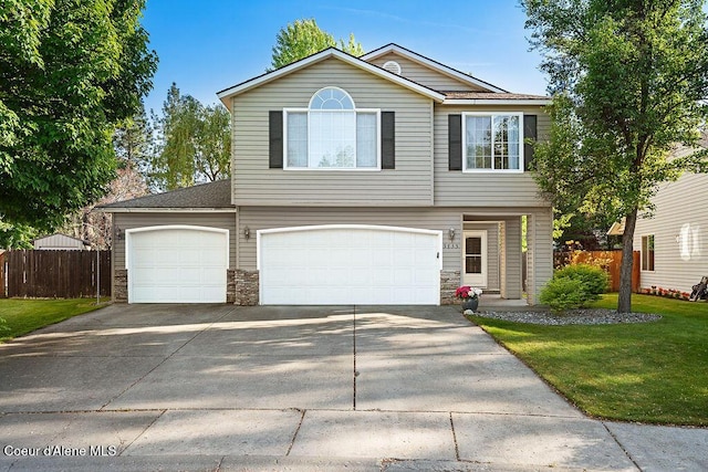 5735 E Steamboat Bnd, Post Falls, ID 83854 - view of front of property featuring driveway, a garage, and stone siding