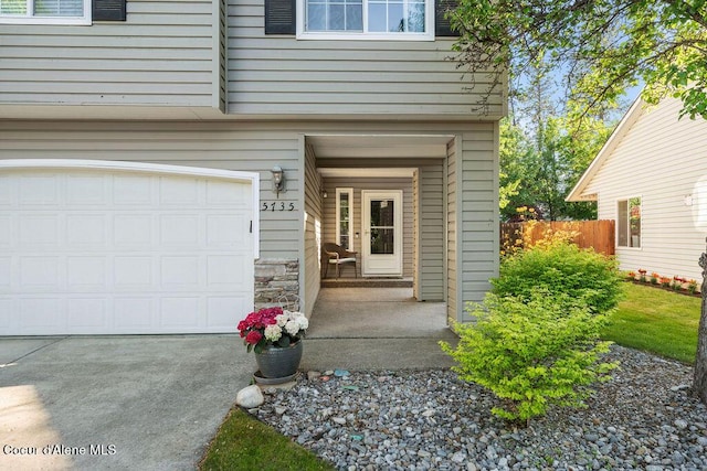 5735 E Steamboat Bnd, Post Falls, ID 83854 - property entrance with an attached garage and stone siding