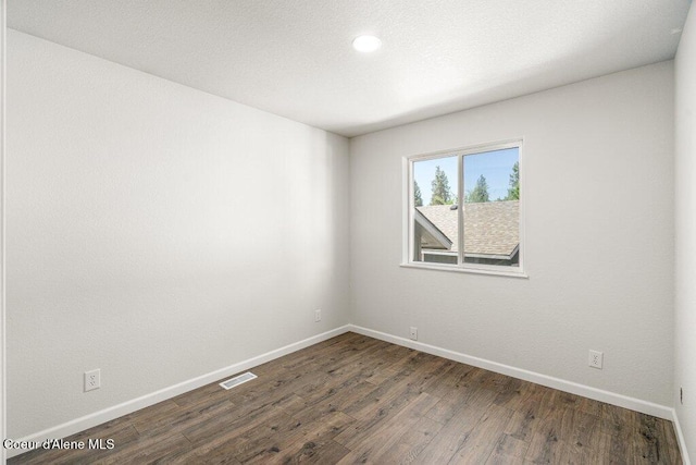 7349 W Crenshaw St, Rathdrum, ID 83858 - spare room featuring baseboards, dark wood-type flooring, and recessed lighting