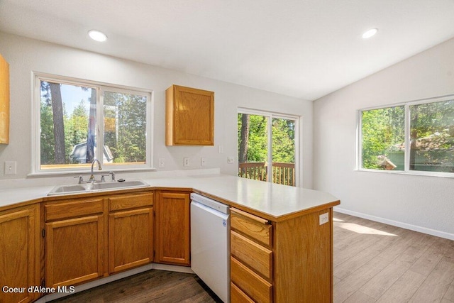 7349 W Crenshaw St, Rathdrum, ID 83858 - kitchen featuring dishwasher, a sink, a peninsula, light countertops, and dark wood-style flooring