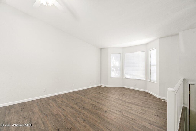 7349 W Crenshaw St, Rathdrum, ID 83858 - empty room with dark wood-style floors, baseboards, and ceiling fan