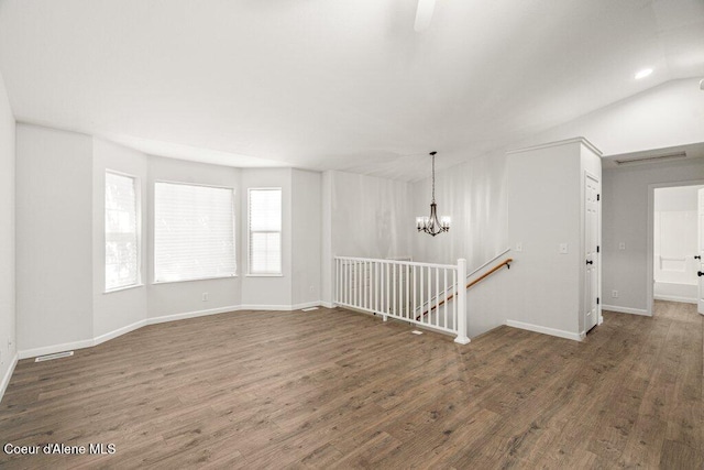7349 W Crenshaw St, Rathdrum, ID 83858 - unfurnished room featuring wood finished floors, a chandelier, and baseboards