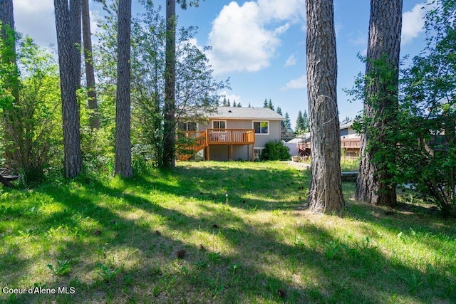 7349 W Crenshaw St, Rathdrum, ID 83858 - view of grassy yard featuring a wooden deck and stairway