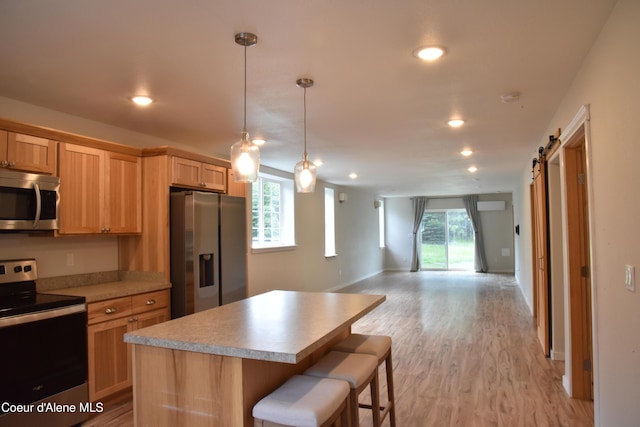 574 Parkside Rd, Plummer, ID 83851 - kitchen featuring appliances with stainless steel finishes, open floor plan, a kitchen island, light wood-type flooring, and recessed lighting