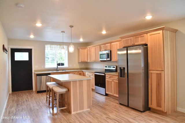 574 Parkside Rd, Plummer, ID 83851 - kitchen with appliances with stainless steel finishes, light brown cabinetry, light countertops, light wood-style floors, and recessed lighting