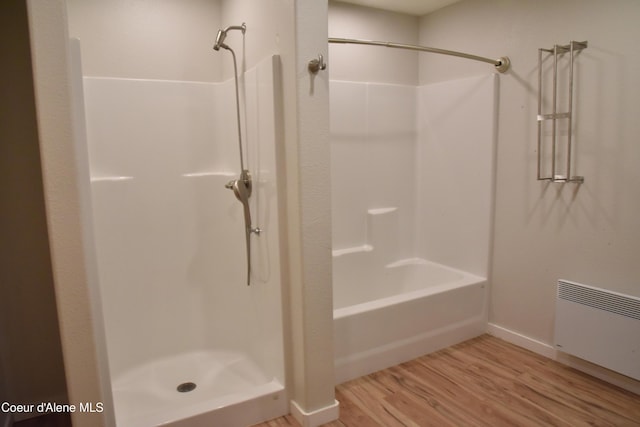 574 Parkside Rd, Plummer, ID 83851 - bathroom with radiator, wood finished floors, baseboards, and washtub / shower combination