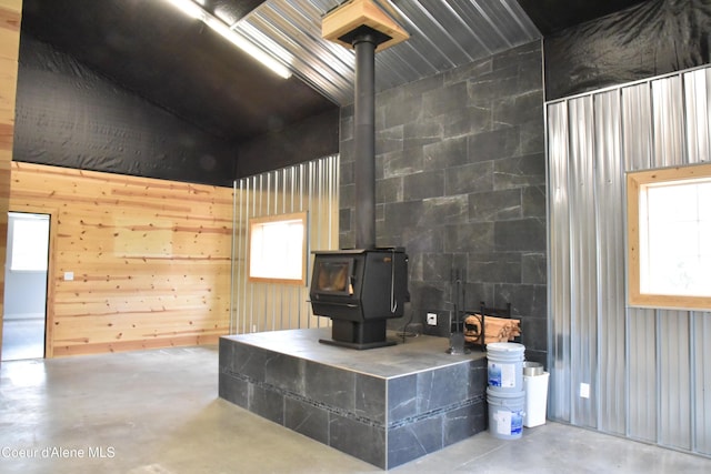 574 Parkside Rd, Plummer, ID 83851 - living room with a wood stove, finished concrete flooring, wood walls, and high vaulted ceiling