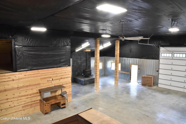 574 Parkside Rd, Plummer, ID 83851 - garage featuring a wood stove, wood walls, and a ceiling fan