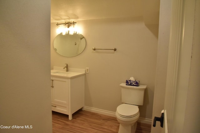 574 Parkside Rd, Plummer, ID 83851 - half bath featuring vanity, wood finished floors, toilet, and baseboards