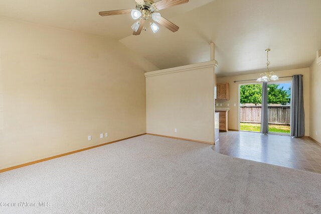321 E Acorn Ave, Coeur Dalene, ID 83814 - unfurnished living room with carpet, baseboards, a ceiling fan, vaulted ceiling, and a chandelier