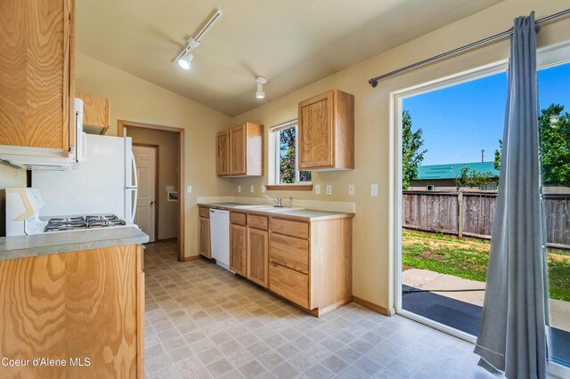 321 E Acorn Ave, Coeur Dalene, ID 83814 - kitchen featuring white appliances, vaulted ceiling, rail lighting, light countertops, and a sink