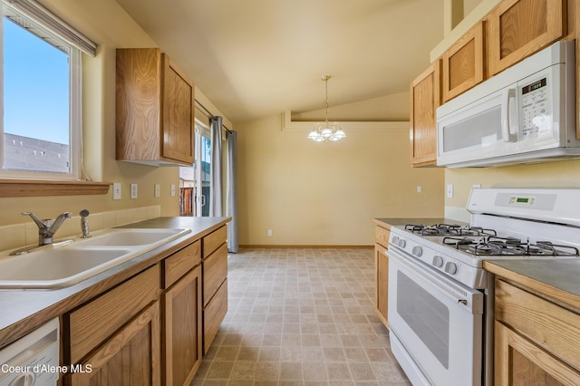 321 E Acorn Ave, Coeur Dalene, ID 83814 - kitchen featuring white appliances, a sink, lofted ceiling, a chandelier, and decorative light fixtures