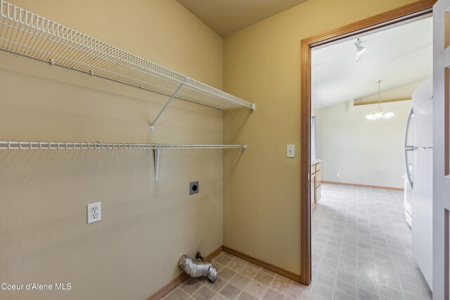 321 E Acorn Ave, Coeur Dalene, ID 83814 - laundry room with electric dryer hookup, a chandelier, and baseboards