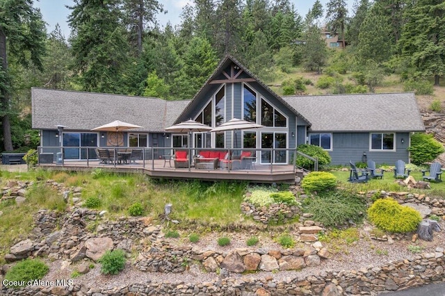 4987 S Bay Pointe Way, Coeur Dalene, ID 83814 - back of property featuring a deck, roof with shingles, and outdoor dining area