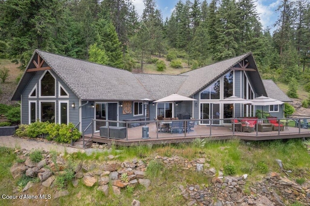 4987 S Bay Pointe Way, Coeur Dalene, ID 83814 - rear view of house featuring a deck and a wooded view