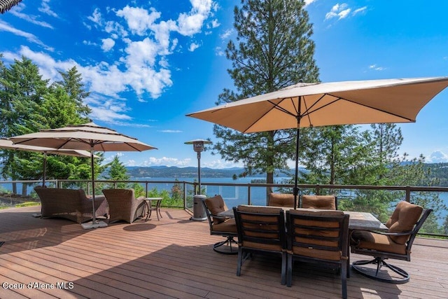 4987 S Bay Pointe Way, Coeur Dalene, ID 83814 - wooden deck with outdoor dining area and a water and mountain view