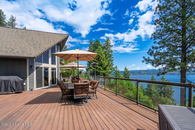 4987 S Bay Pointe Way, Coeur Dalene, ID 83814 - wooden deck with grilling area, outdoor dining space, and a water view
