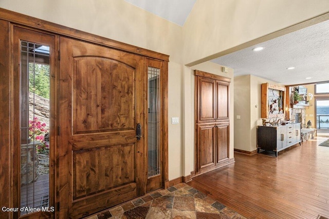 4987 S Bay Pointe Way, Coeur Dalene, ID 83814 - entryway with plenty of natural light, baseboards, a textured ceiling, recessed lighting, and dark wood finished floors