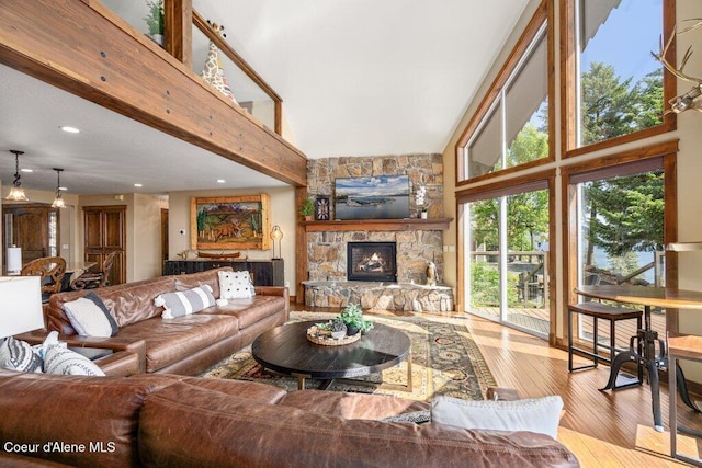 4987 S Bay Pointe Way, Coeur Dalene, ID 83814 - living room with a high ceiling, wood-type flooring, a fireplace, and recessed lighting