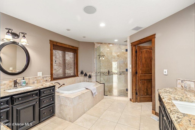 4987 S Bay Pointe Way, Coeur Dalene, ID 83814 - bathroom featuring two vanities, a stall shower, a garden tub, tile patterned flooring, and recessed lighting