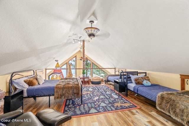 4987 S Bay Pointe Way, Coeur Dalene, ID 83814 - bedroom featuring lofted ceiling, wood finished floors, and a textured ceiling